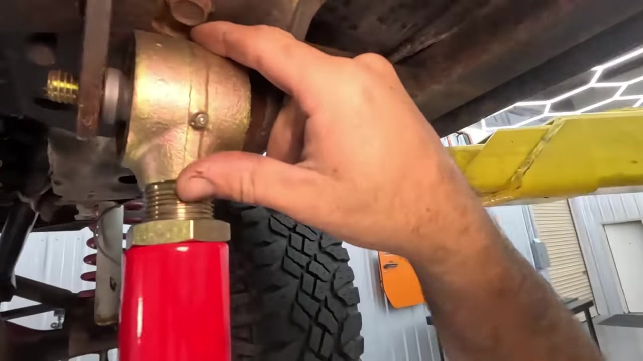Removing old lower long arm from XJ Cherokee on the lift