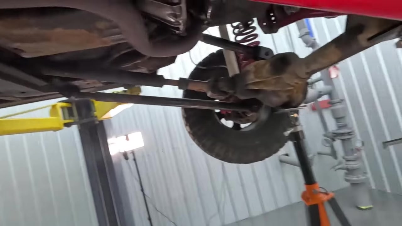 Torquing lower control arm bolt on the lift with torque wrench