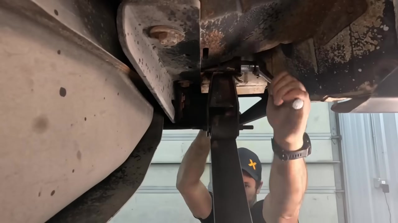 Working underneath the XJ removing old leaf spring shackle hardware