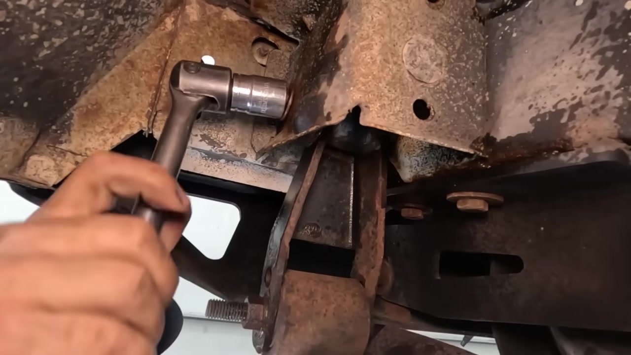 Using a ratchet to remove the old rusted shackle bolts on a Cherokee XJ