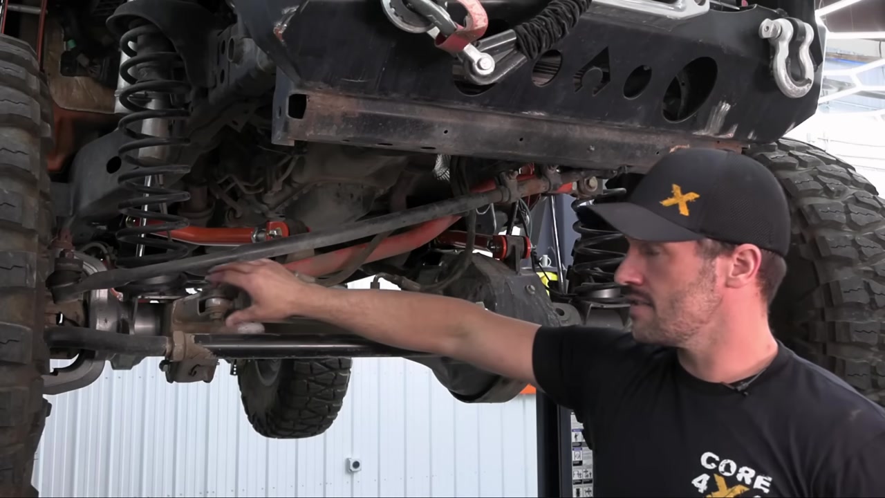 Measuring factory steering components under a Jeep Wrangler JK before removal
