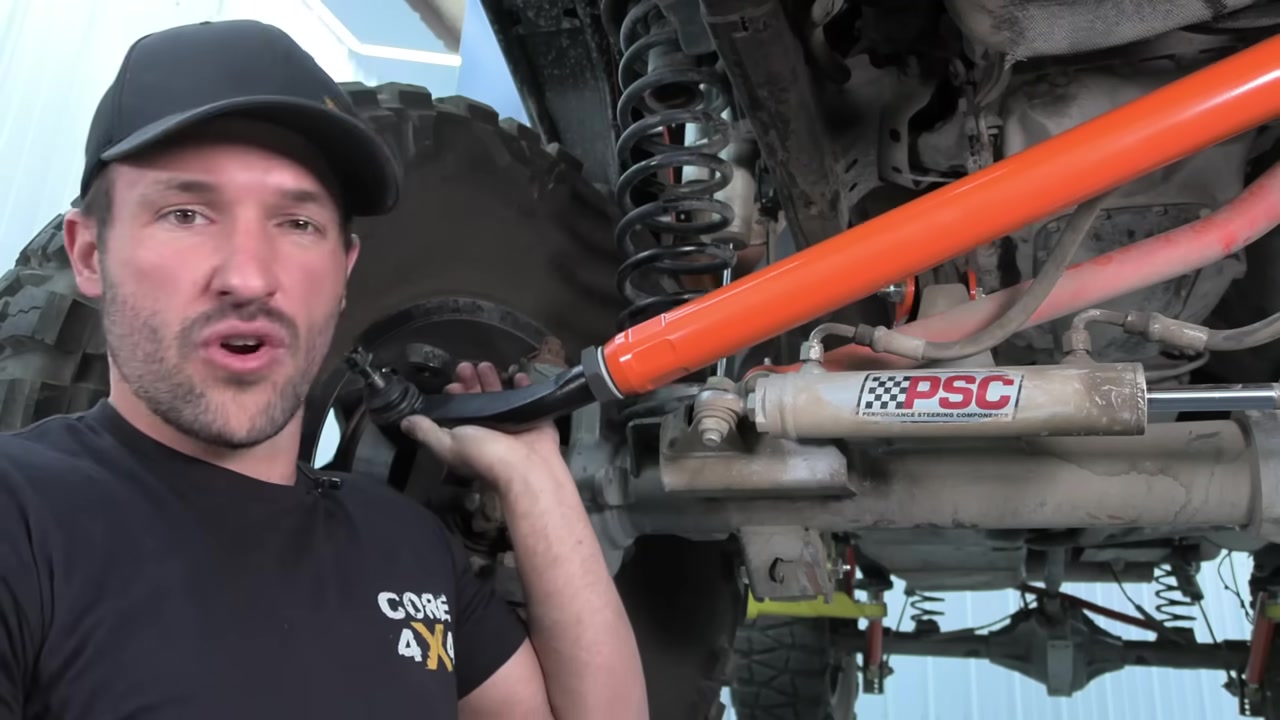 Core 4x4 2.5 ton orange steering kit installed under Jeep Wrangler JK