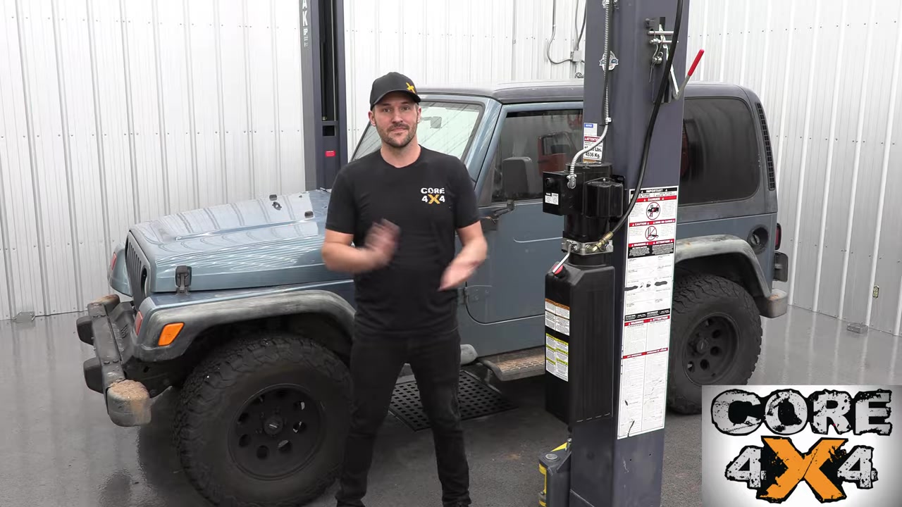 Spence from Core 4x4 standing next to a TJ Wrangler in the shop before the lift kit install