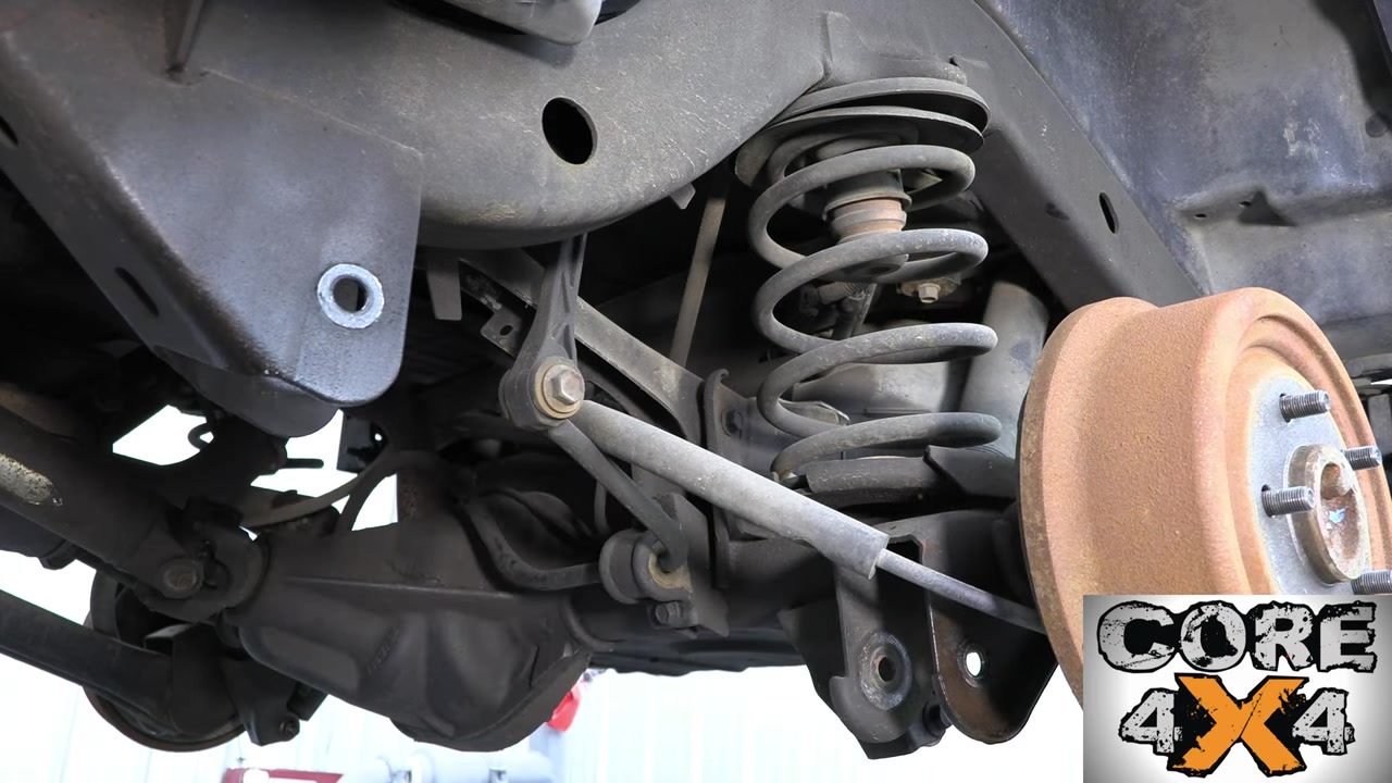 Rear suspension teardown showing the TJ rear axle with springs and shocks removed