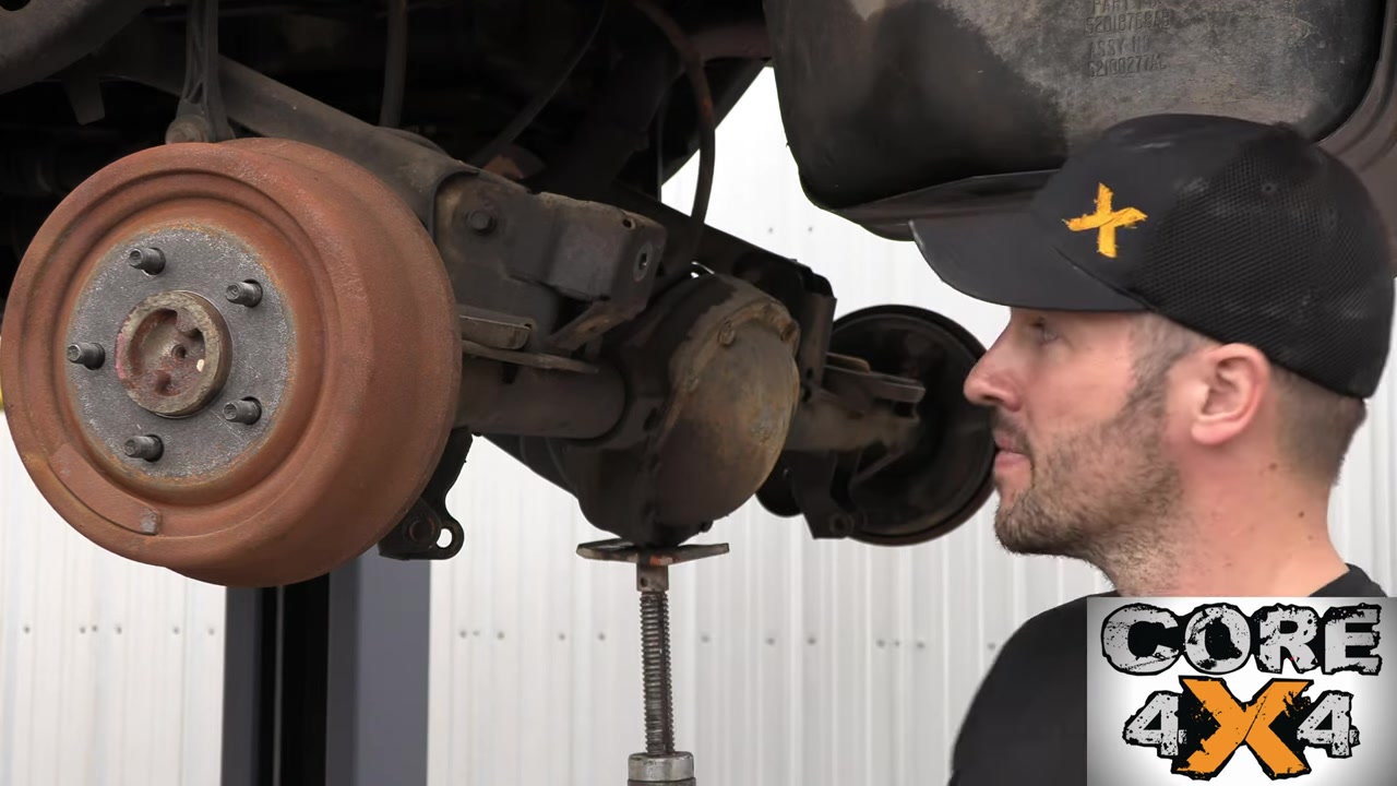 Spence examining the rear track bar relocation bracket on the TJ