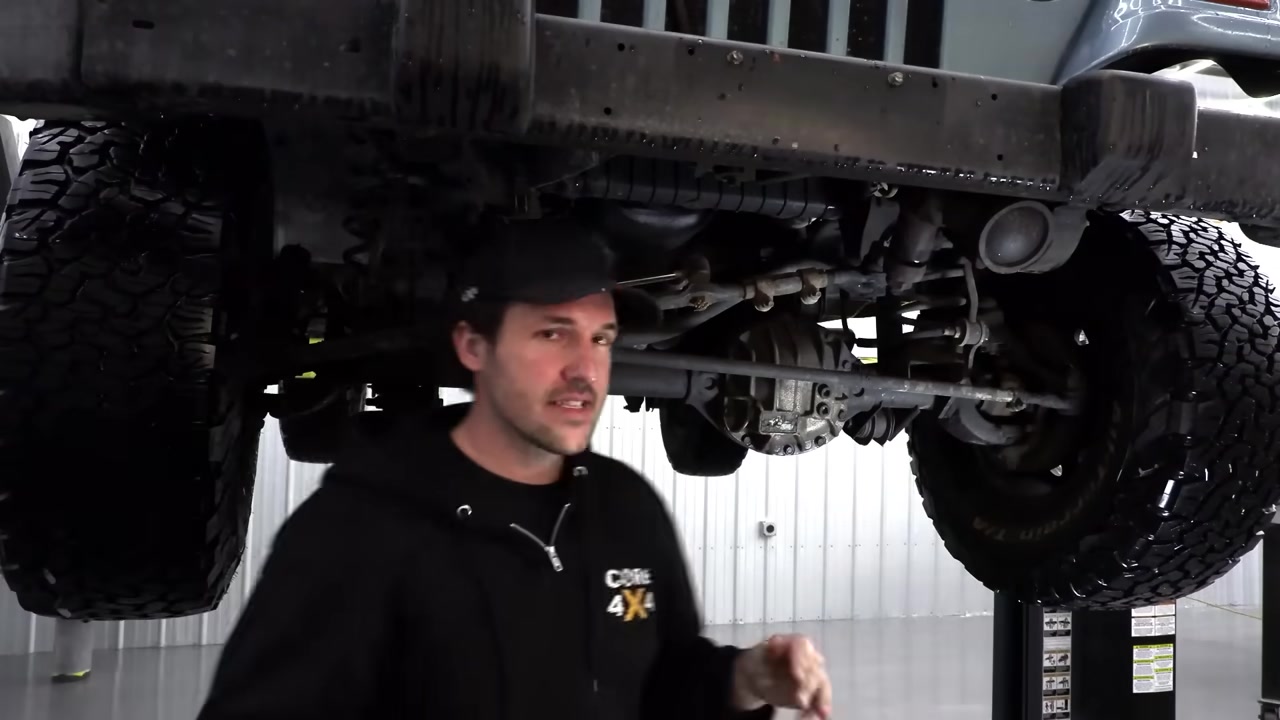 Underside of TJ Wrangler showing the factory track bar connecting frame to axle