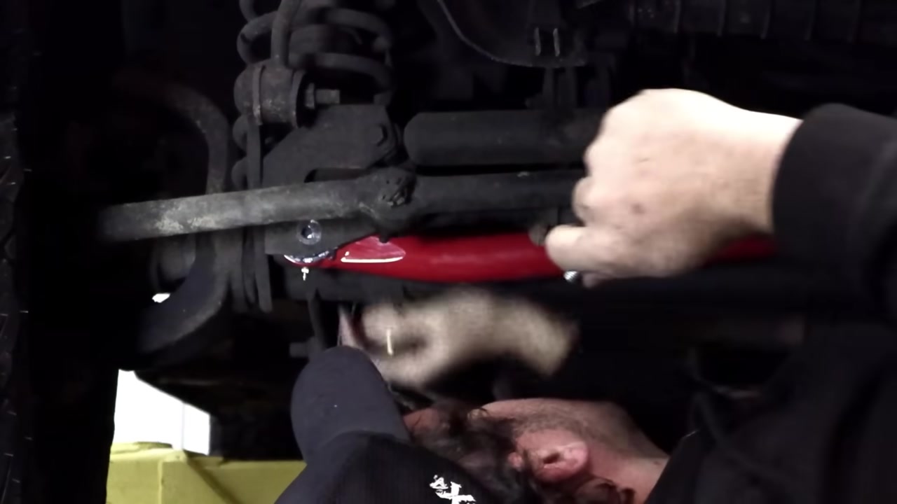 Installing the track bar axle-side bolt using the steering wheel alignment trick