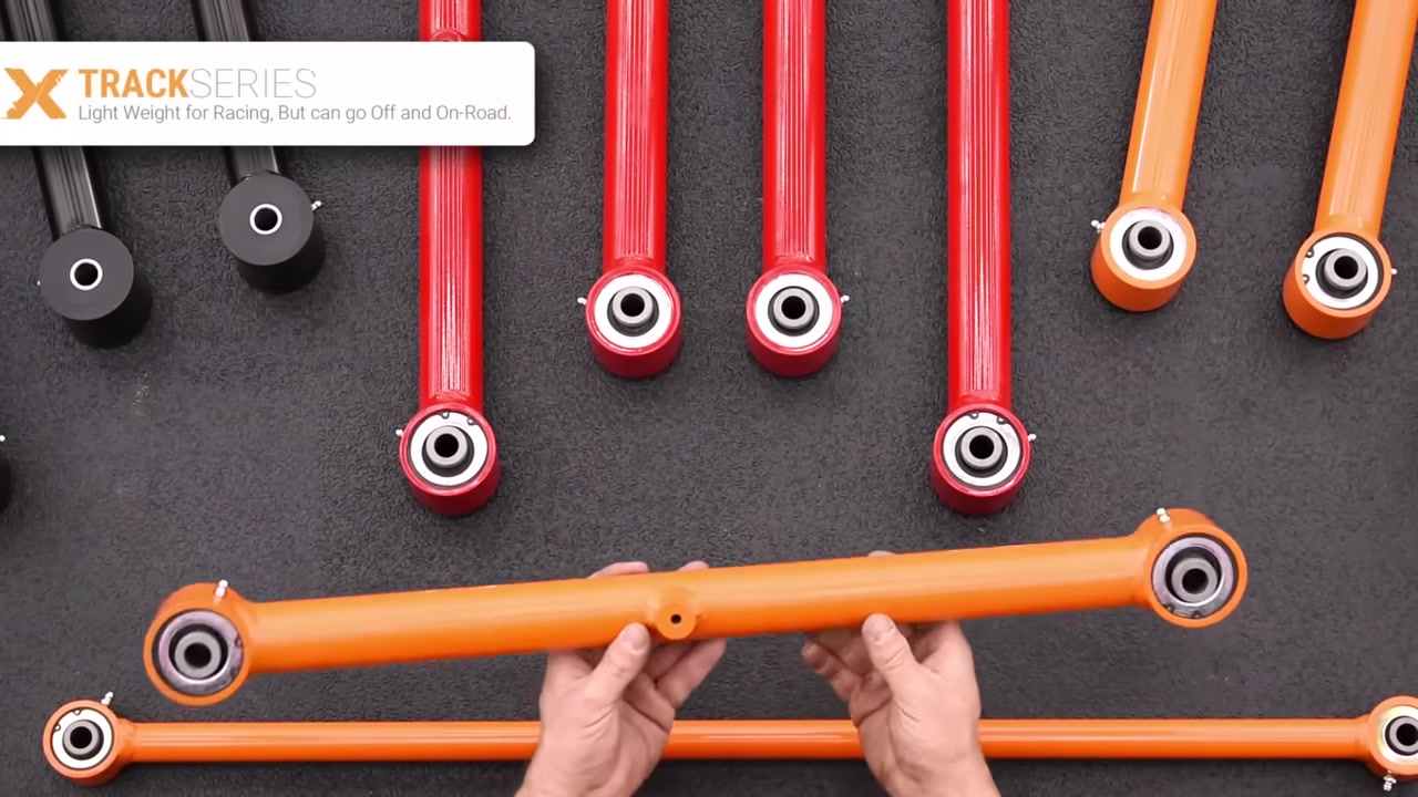 Core 4x4 Track Series control arm with RockJock Johnny Joints at both ends, shown in orange