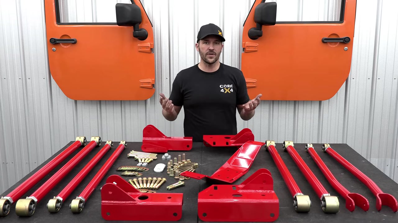 Core 4x4 ZJ long arm kit laid out on the table showing all eight arms, brackets, crossmember, and Grade 8 hardware