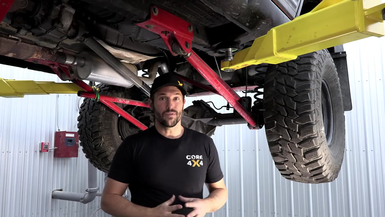 Underneath the ZJ Grand Cherokee showing the Core 4x4 long arm brackets and red control arms after six years of use