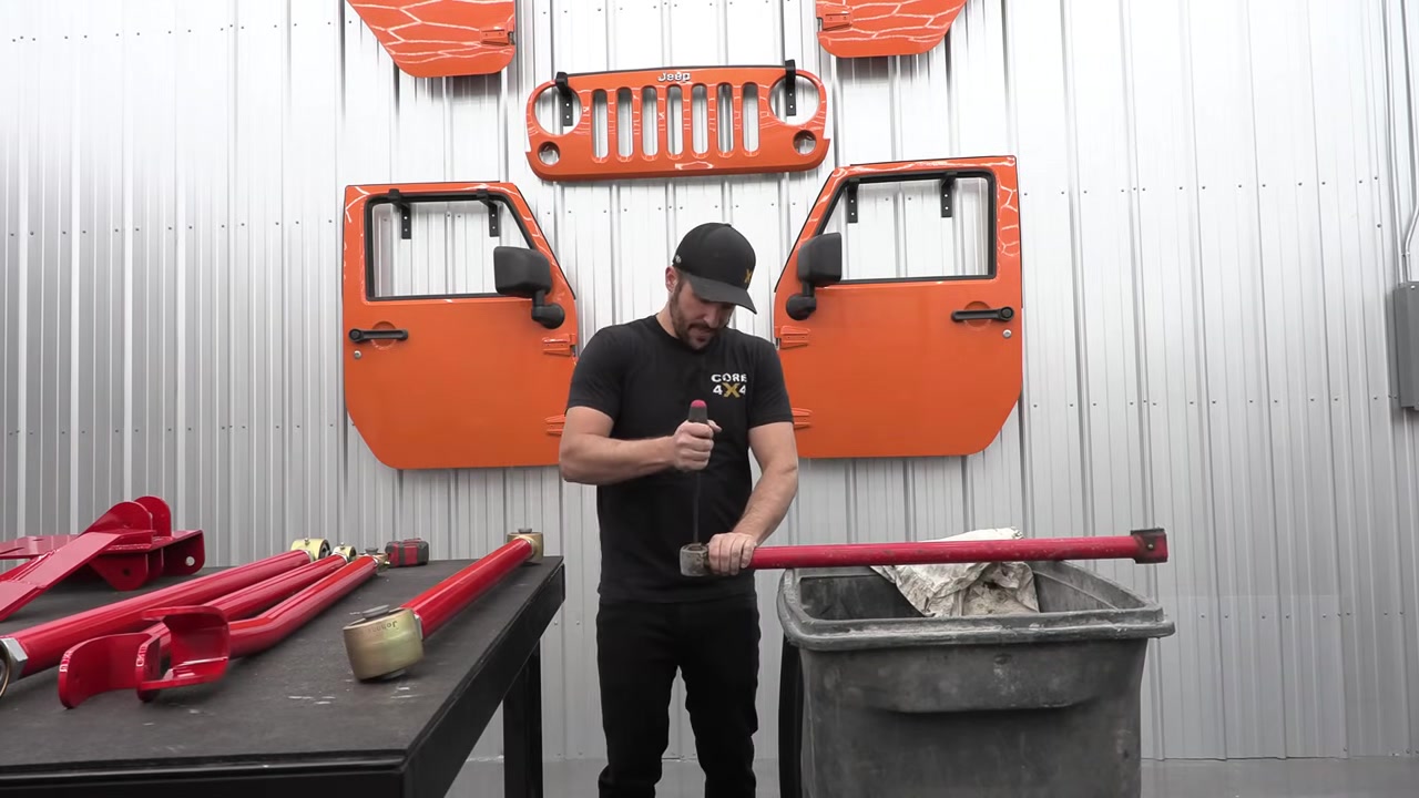 Spence measuring the old ZJ control arm length at the workbench before setting the new Crawl Series arm