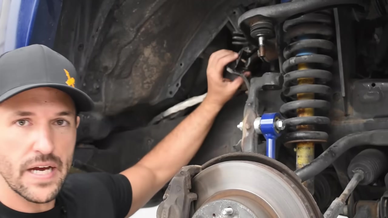 CORE 4X4 upper control arm installed on Toyota Tacoma with improved coilover clearance visible in the wheel well