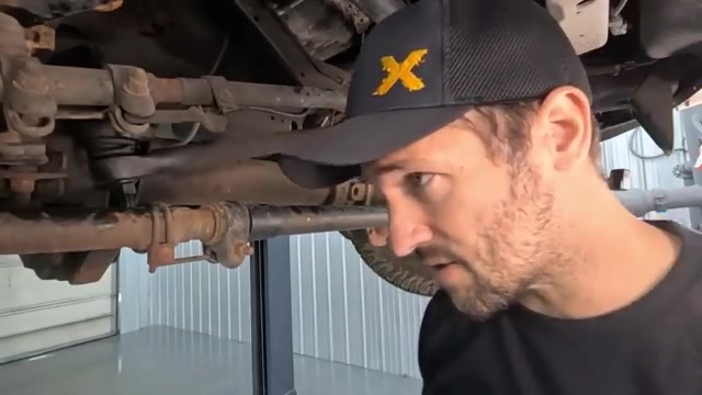 Removing rusty factory steering components from Ford F-350 front axle