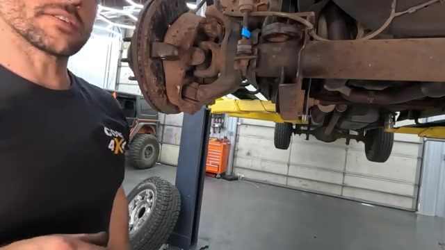 Axle-mounted ball joint area on Ford F-350 during trackbar and steering replacement