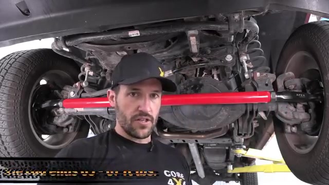 Core 4x4 red aluminum tie rod being installed on Ram 2500 front axle