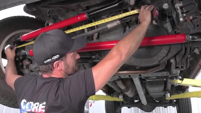 Measuring the new Core 4x4 drag link with a tape measure to match factory length on Ram 2500