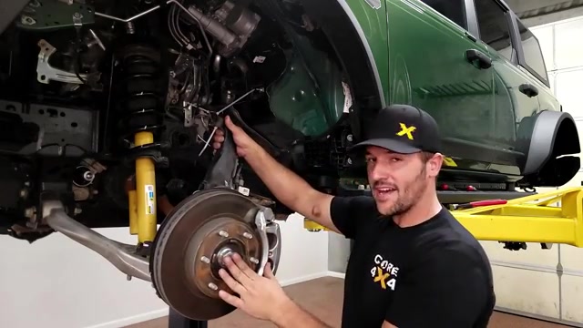 Working around the CV axle on the Ford Bronco to remove the front coilover