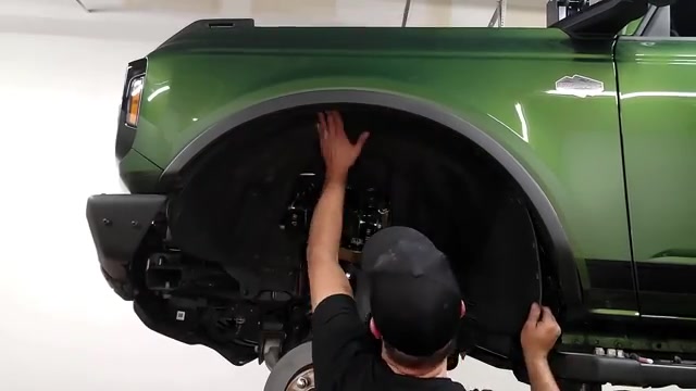 Completed driver-side suspension with Falcon coilover and Icon UCA installed on the green Bronco