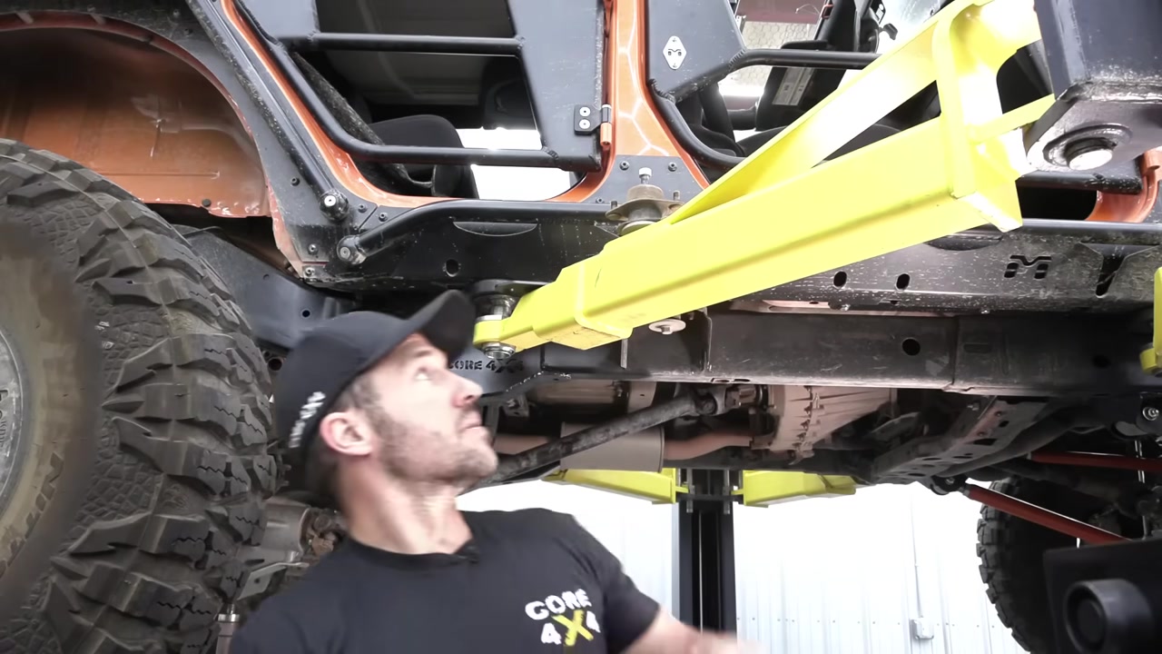 Body mount relocation bracket installed on the JK Wrangler frame for long arm clearance