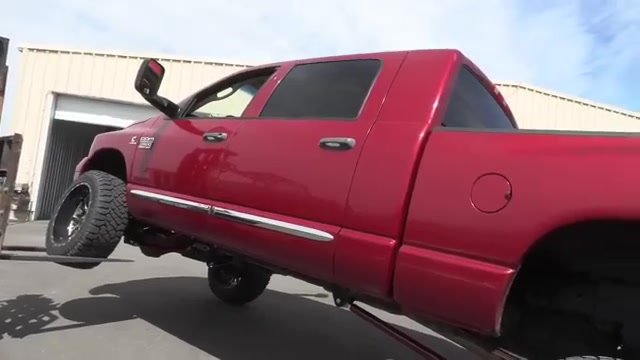 Red third-gen Ram 3500 Cummins at the Core 4x4 shop before long arm kit install