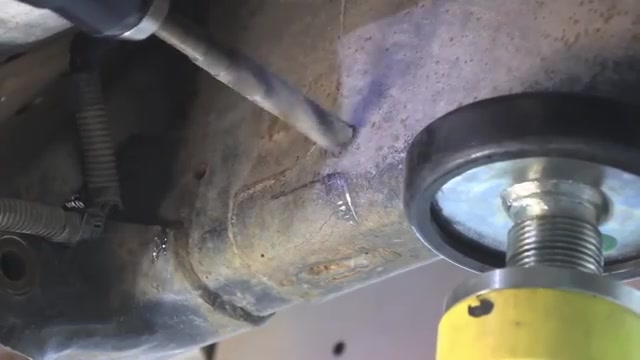 Closeup of marked hole locations on the Ram 3500 frame for long arm bracket drilling