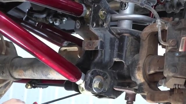 Core 4x4 red long arm control arms installed on the passenger side axle of a Ram 3500