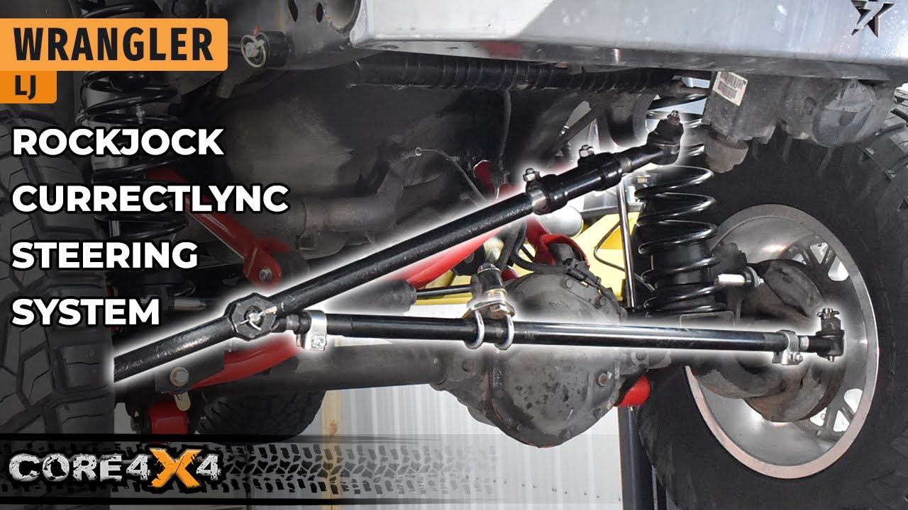 Installed RockJock Currectlync steering system on the Core 4x4 LJ Wrangler showing the heavy-duty tie rod and drag link under the front axle