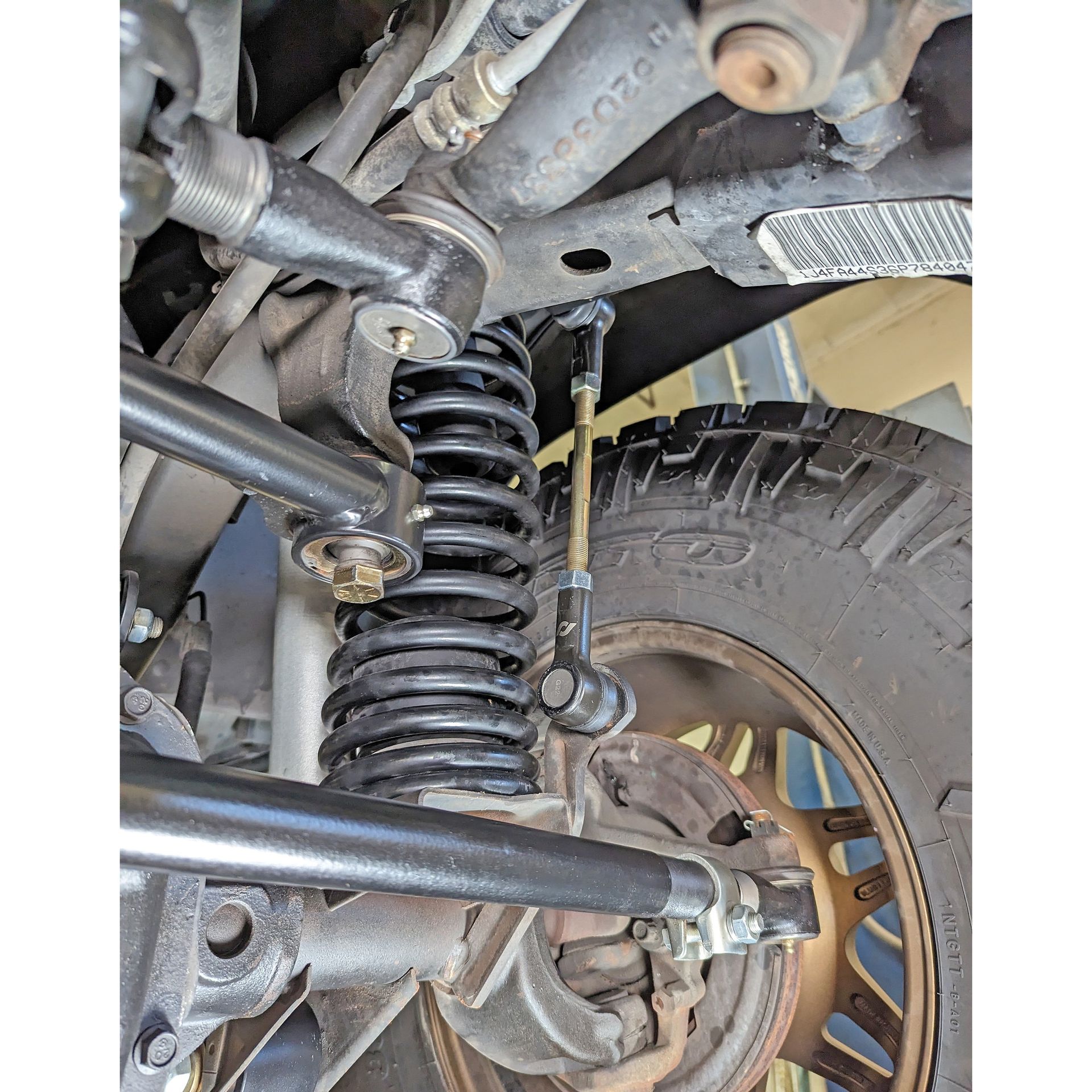 Side-by-side comparison of stock tie rod tube end versus RockJock Currectlync heavy-duty tie rod tube end showing the size difference in adjusting clamps