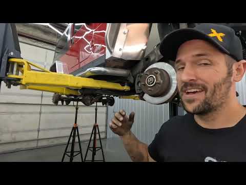 Adjustable rear track bar being installed on the LJ Wrangler with the trackbar relocation bracket
