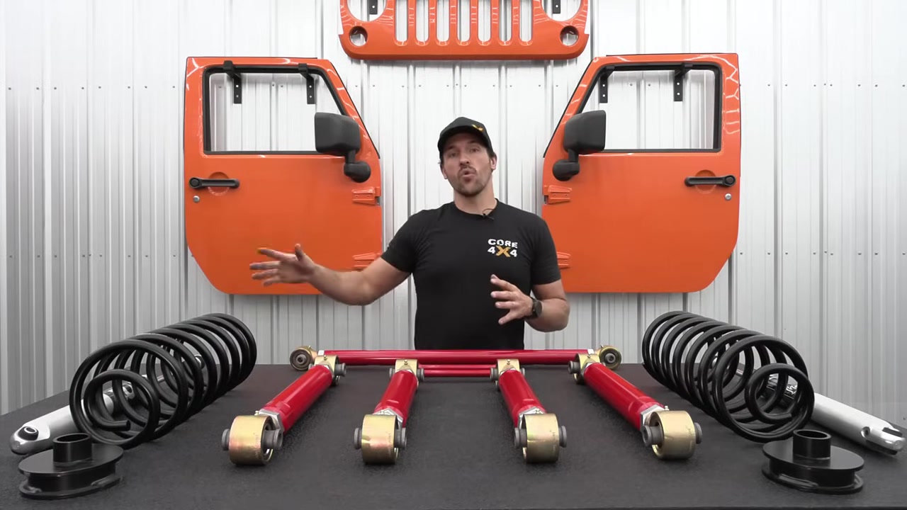 Core 4x4 aluminum series control arms, coils, and shocks laid out on workbench for Ram 2500 rear suspension