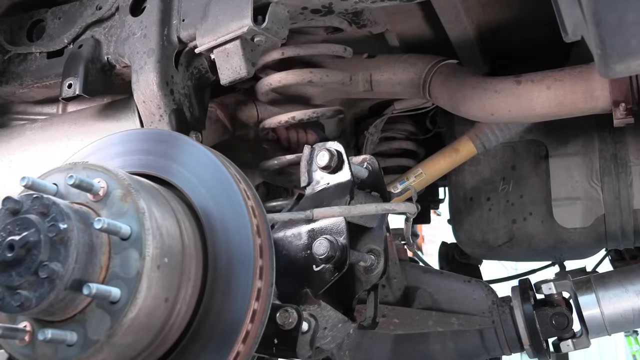 Ram 2500 rear axle stripped of all suspension components showing coil spring pocket and brake rotor