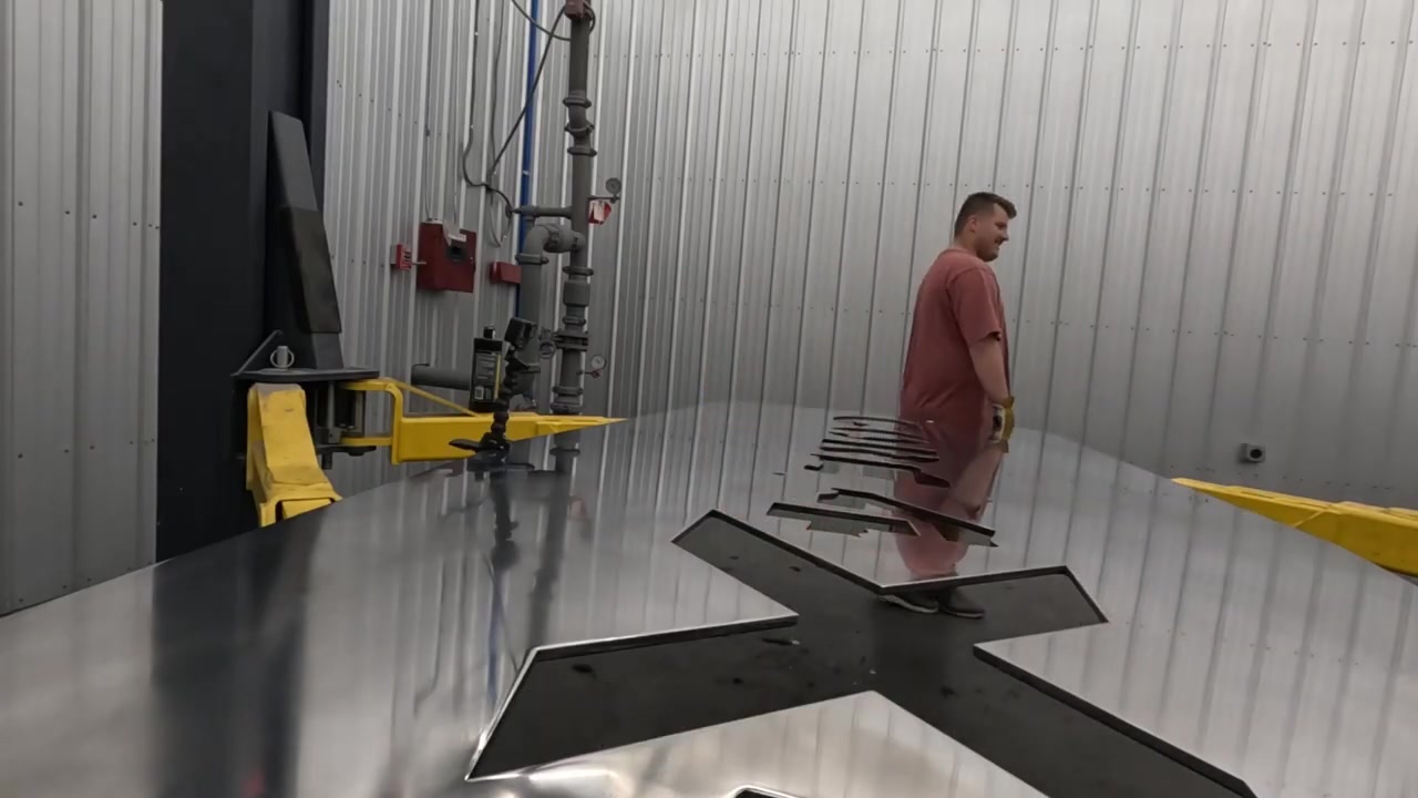 The polished aluminum tabletop with the Core 4x4 logo reflecting Tyson walking in the background, ready to be moved upstairs