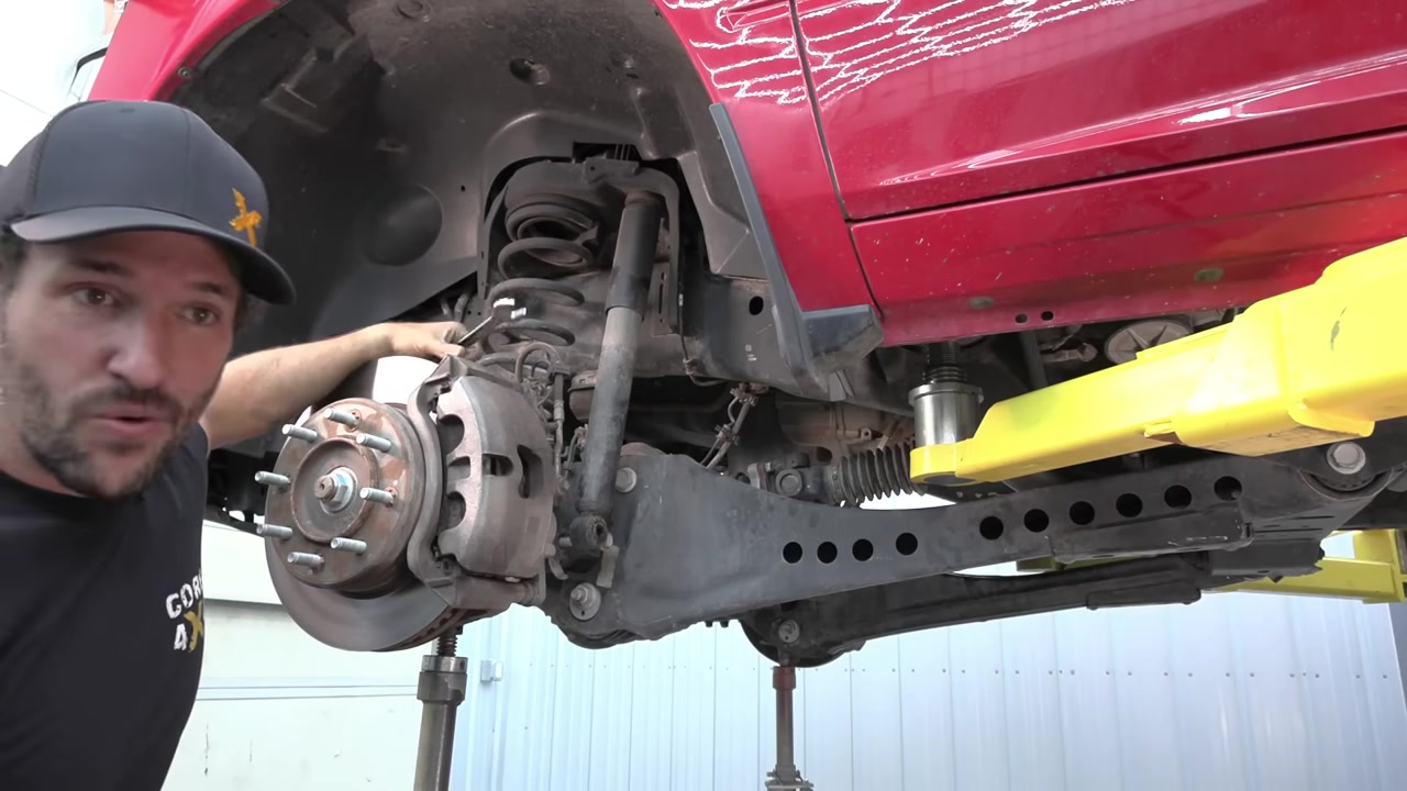 Spence removing the factory front suspension components from underneath the Ram 2500