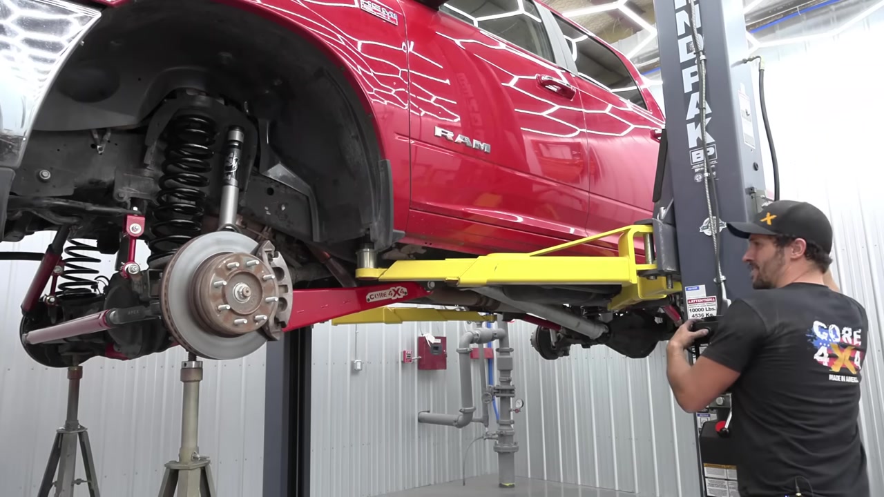 Ram 2500 front suspension with new 3-inch lift coils and Fox shocks installed, radius arms visible