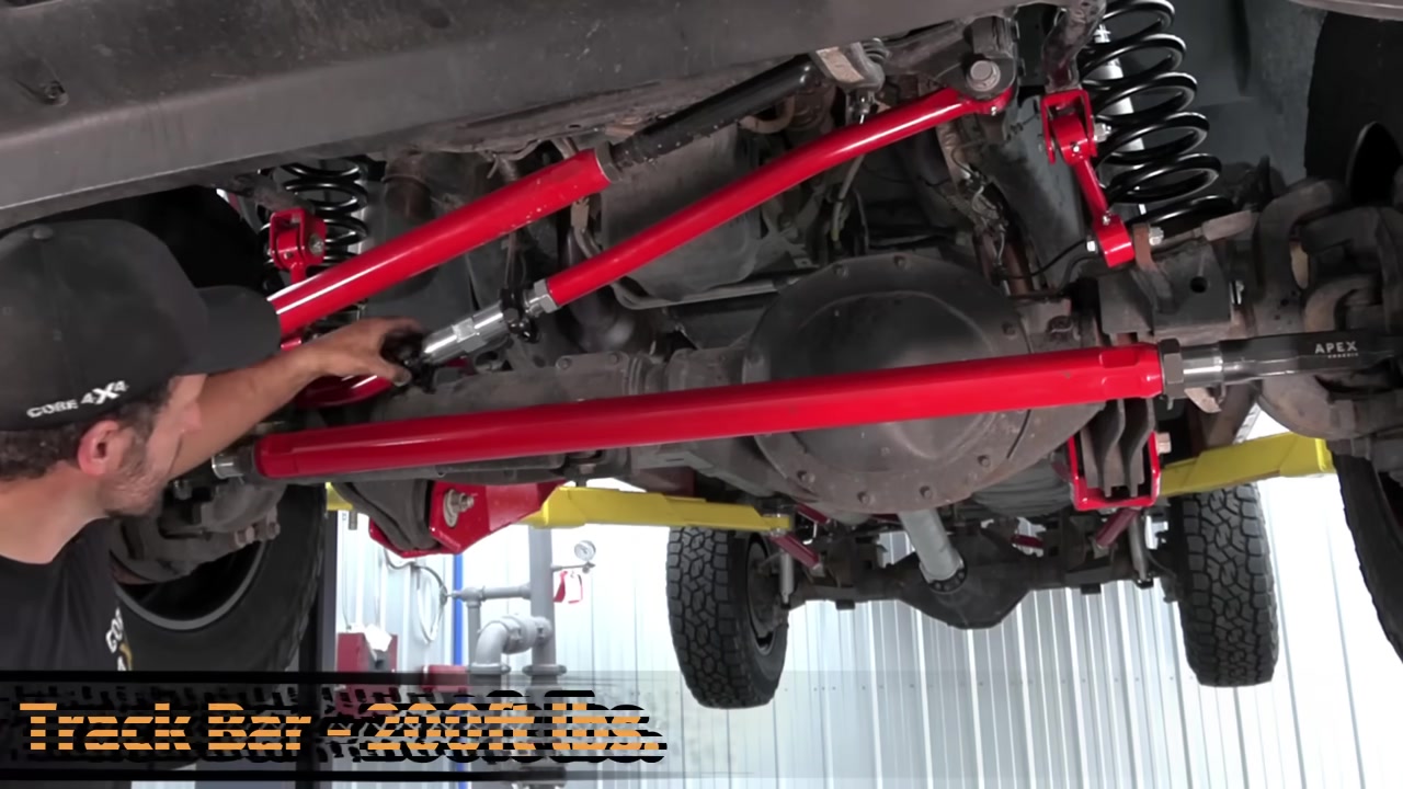 Torquing the track bar on the Ram 2500 front axle with torque specs overlay showing 200 ft-lbs