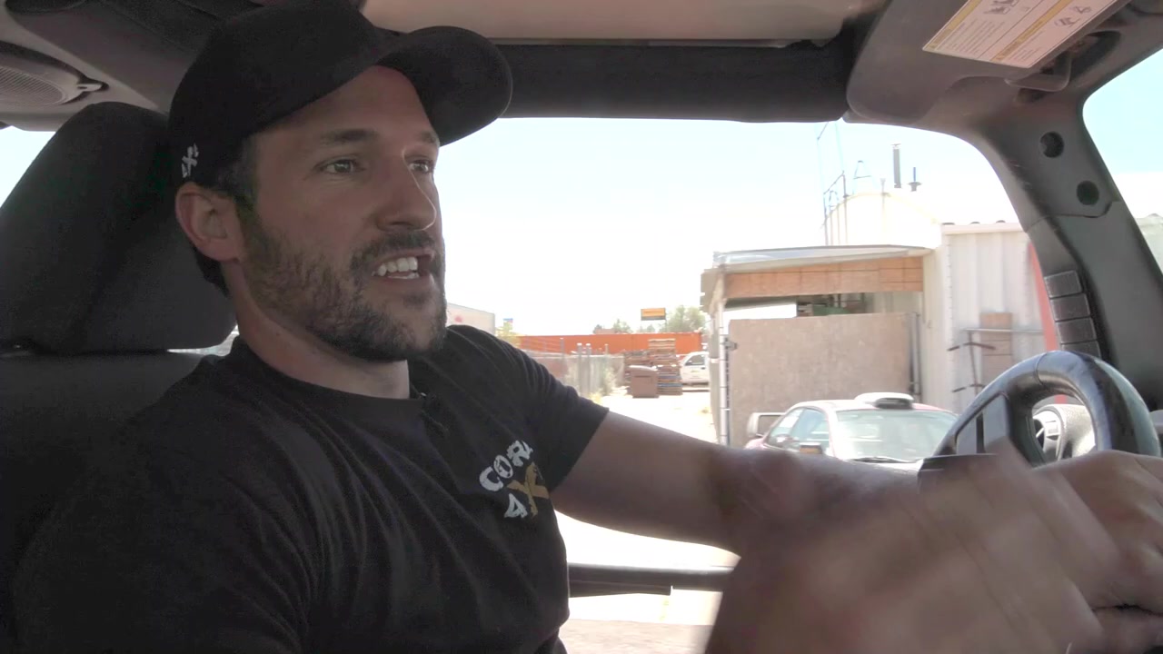 Spence driving the Jeep JK to a loading dock ramp to flex the suspension for bump stop measurement