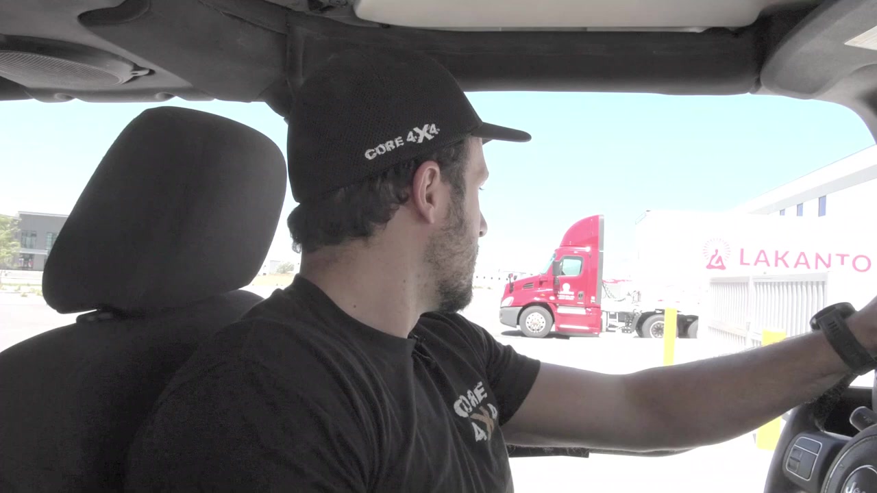 Spence looking at the underside of the Jeep JK measuring the clearance between tire and fender at full tuck
