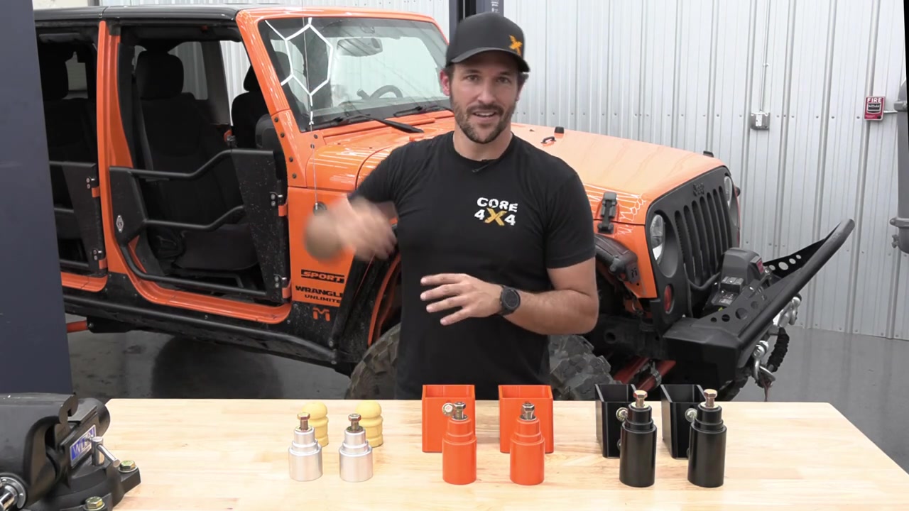 Core 4x4 bump stop extensions on the workbench in multiple sizes showing the 2-inch, 3-inch, and 4-inch options for the Jeep JK