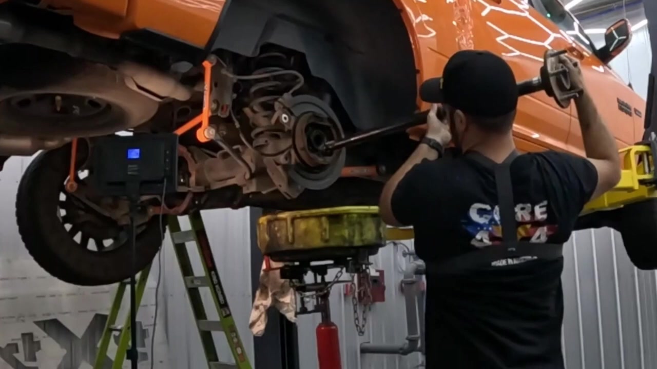 Pulling the rear axle shaft from the Ram 1500 axle housing on the lift