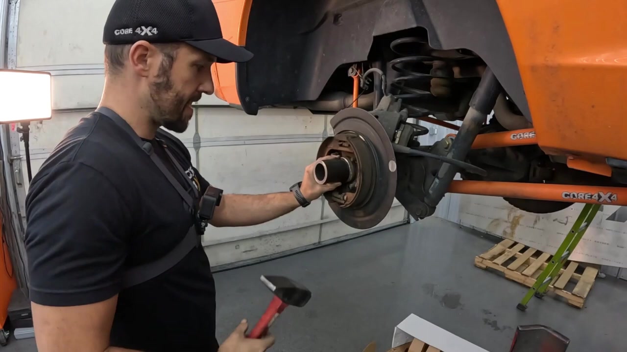 Using DOM tubing as a bearing driver to press the new axle bearing into the Ram 1500 axle housing