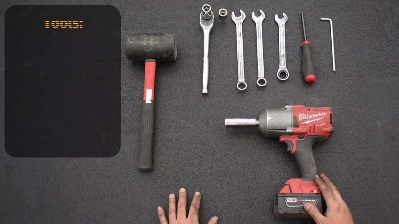 Tools laid out on a workbench for the Tacoma sway bar end link install including impact wrench, dead blow hammer, ratchet, wrenches, and allen wrench
