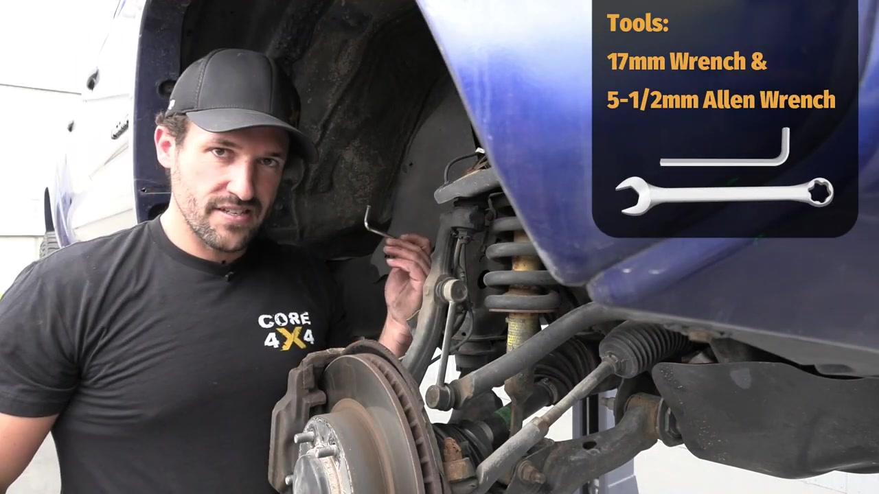 Close-up of the Tacoma front suspension with sway bar visible and tools needed for end link removal shown: 17mm wrench and 5.5mm allen wrench