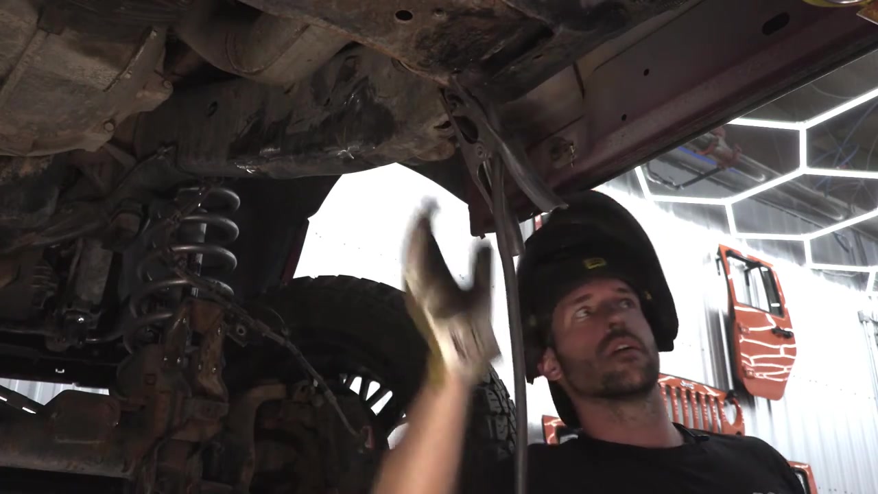 Cleaned-up Ram 3500 frame rail after factory control arm bracket removal, ready for long arm kit installation