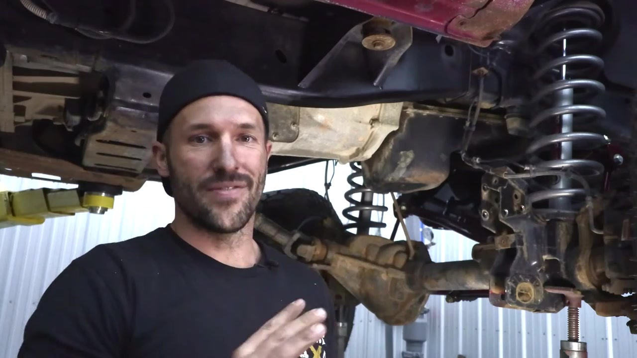 Ram 3500 frame after complete tear down and cleanup, with factory control arm mounts removed and frame painted, ready for long arm kit