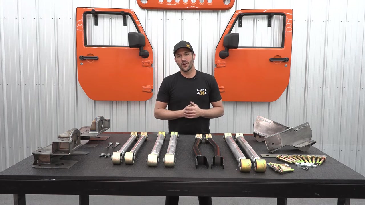 Core 4x4 JK long arm kit laid out on table showing brackets, control arms, and hardware