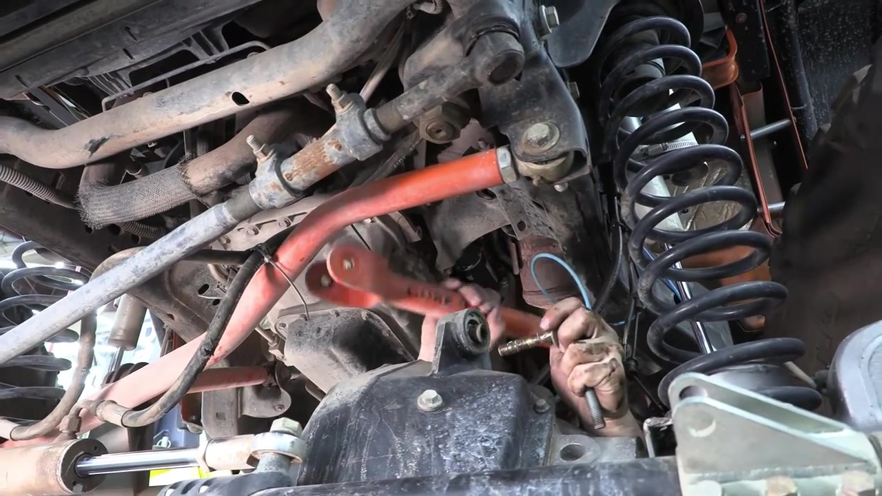 Removing old red Core 4x4 Crawl Series control arm from JK Wrangler front axle