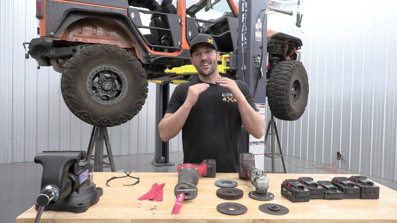 Cutting tools laid out on workbench including sawzall, grinder, flap discs, cut-off wheels, and Milwaukee batteries