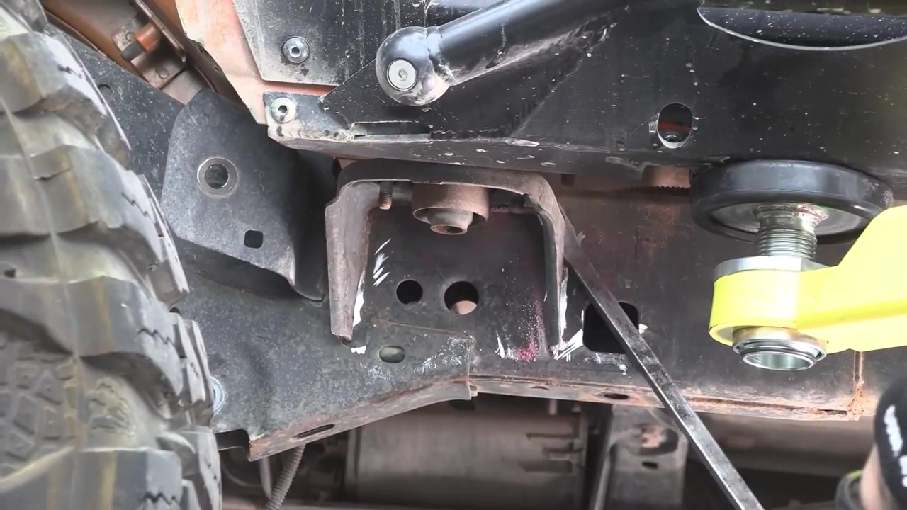 Rear bracket and body mount area of JK Wrangler frame after partial bracket removal