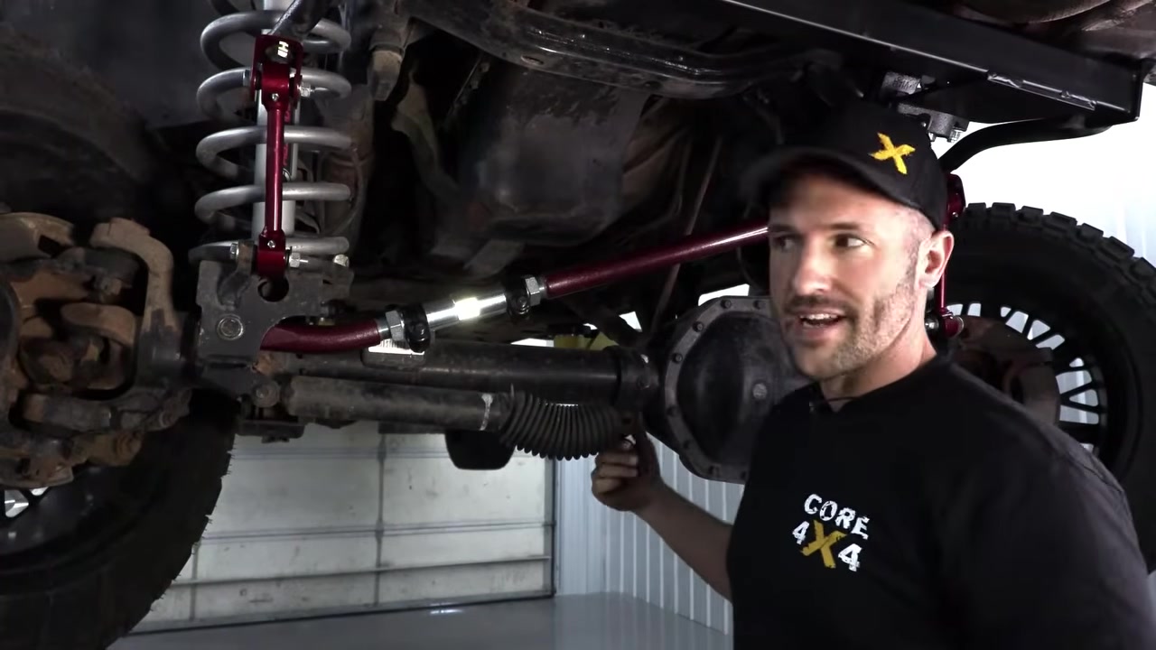 New steering stabilizer being installed on the Ram 3500 with the steering box brace visible