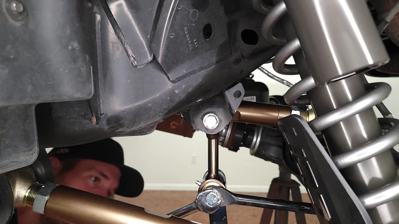New Core 4x4 Crawl Series end link being bolted into place on the Bronco rear suspension, Johnny Joint visible at the mounting point